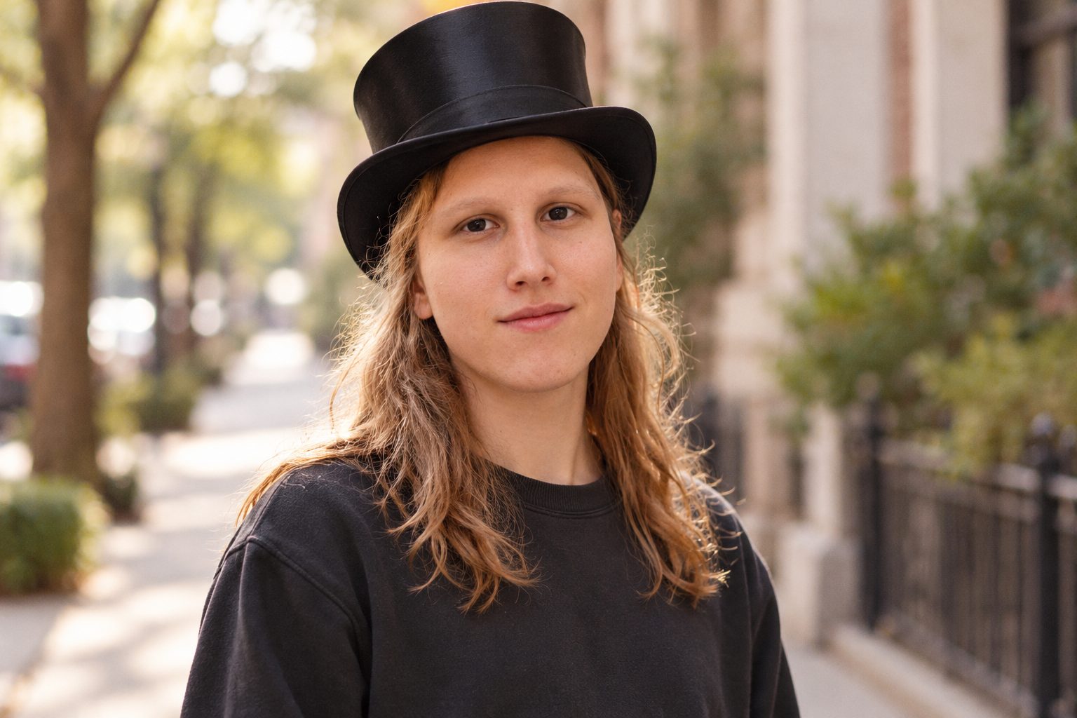 A recipient standing proudly in a new black silk top hat